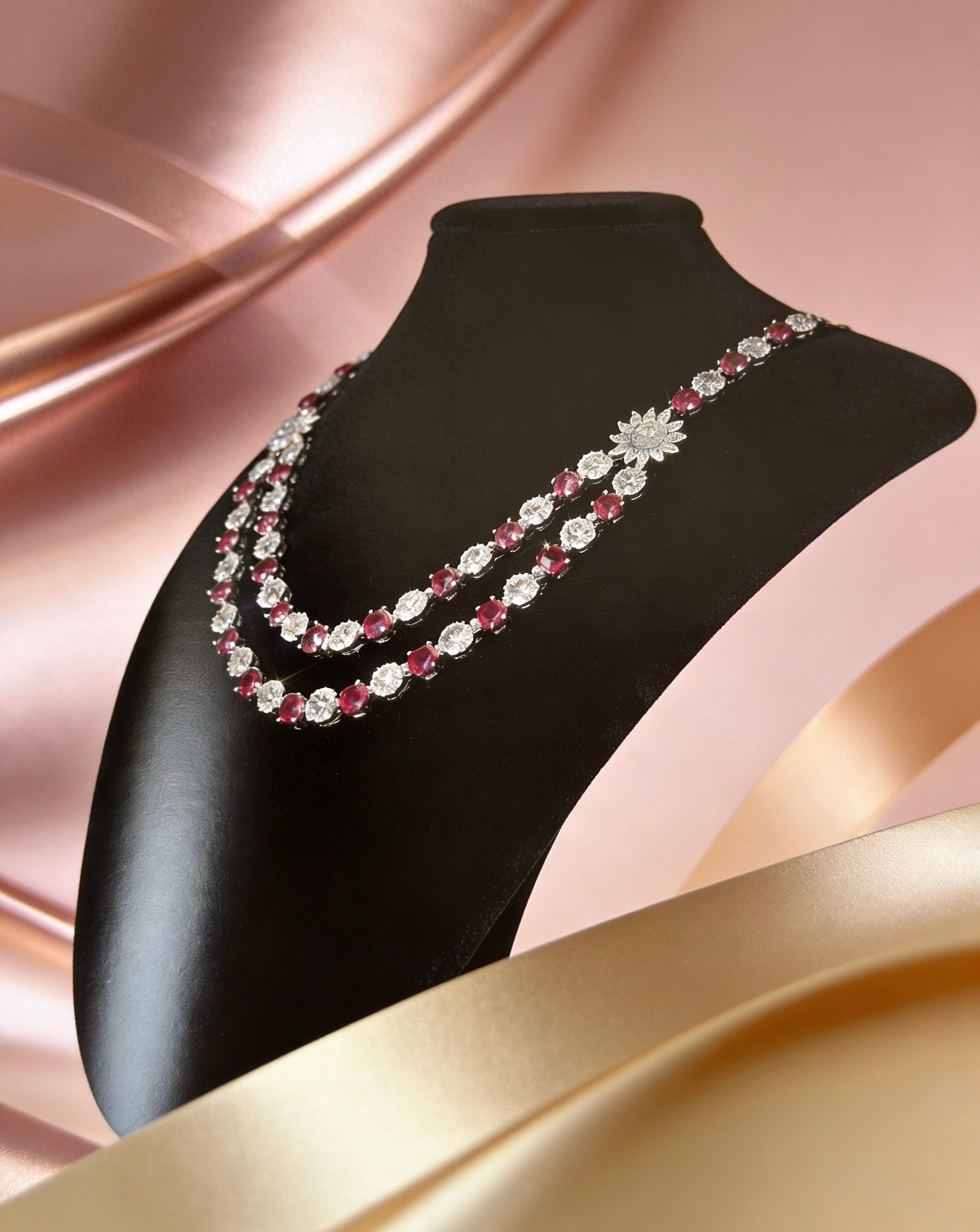 Double-strand necklace featuring ruby red stones and white American diamonds with a sunburst centrepiece. Elegant bridal jewellery for weddings, sangeet, and special occasions.